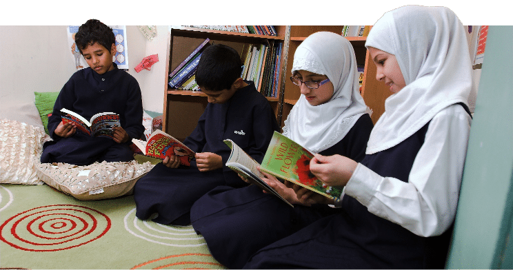 Kids reading book, sitting on the floor
